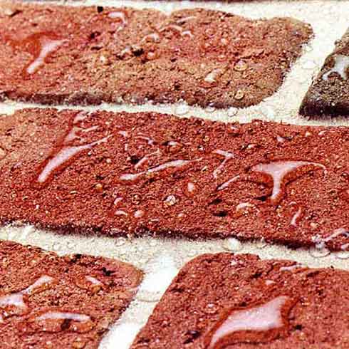 Water beading on red bricks after sealing