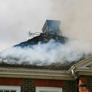 a roof and chimney surrounded by smoke