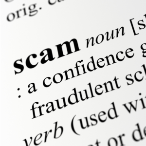 a close up picture of the word "scam" in the dictionary