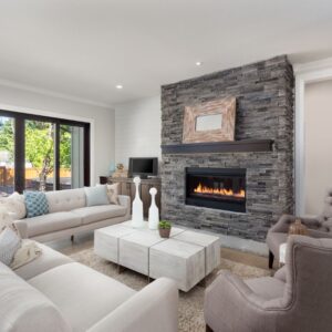 gray brick fireplace in a living room with white couches and nice decor